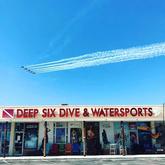 front of Deep Six building with Blue Angles flying over front of Deep Six building with Blue Angles flying over